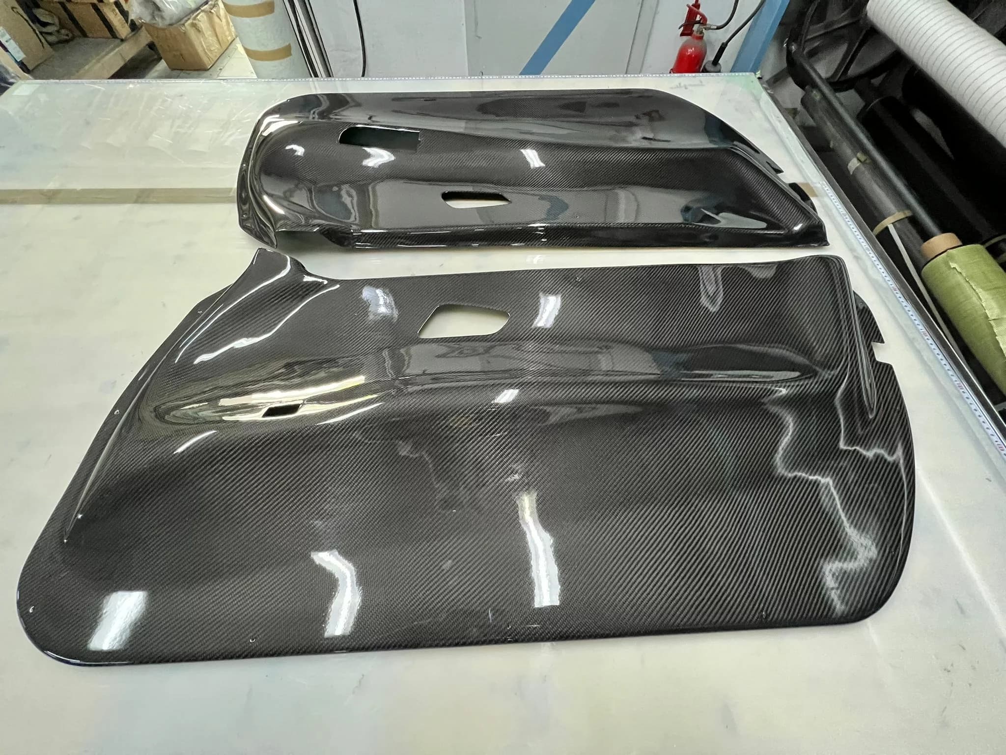 Carbon Türinnenverkleidung BMW E92 aus Sichtcarbon, Paar auf Werkbank von oben